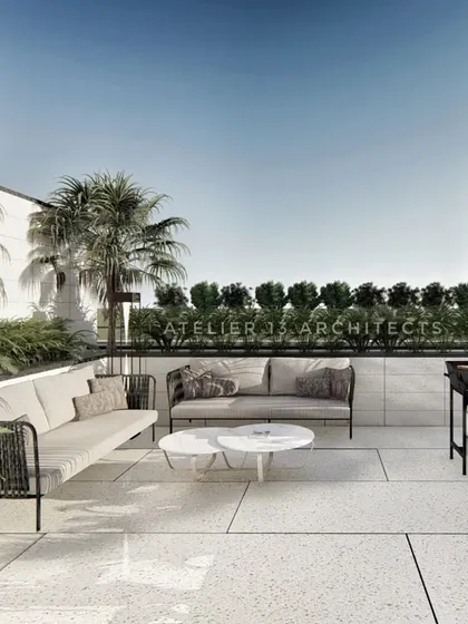 This section of the terrace is designed for casual gatherings and outdoor cooking. The space includes comfortable seating and a modern barbecue grill, set against a backdrop of lush perimeter planting that ensures privacy while creating a garden-like atmosphere.