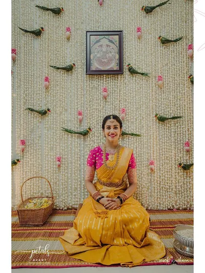 The beauty of a wedding is in its sacred rituals. I designed this serene backdrop for a South Indian ceremony using a curtain of fragrant tuberose, accented with delicate lotus buds and charming leaf parrots, creating a truly special space for the bride.