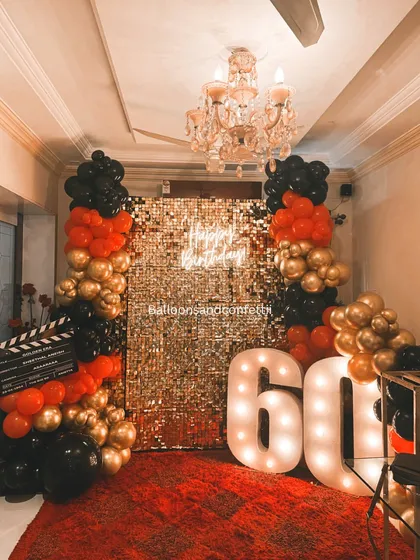 Turning 60 is a golden milestone, and the decor should match. I created this glamorous Hollywood-themed setup with a gold shimmer wall, a bold red, black, and gold balloon arrangement, and giant light-up marquee numbers. It’s sophisticated, celebratory, and full of star quality.