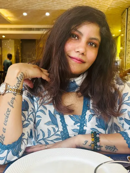 A close-up portrait wearing the floral kurta, showing my 'Be a voice for the voiceless' tattoo, blending personal values with my style.
