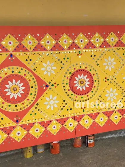 A finished Lippan wall panel featuring traditional geometric and floral patterns from Kutch. The bright yellow and red color scheme is classic, making it a vibrant addition to any interior design seeking an ethnic touch.