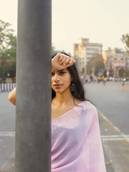 Using a simple street pole to create a game of peek-a-boo. This adds a playful and intriguing element to a street portrait.