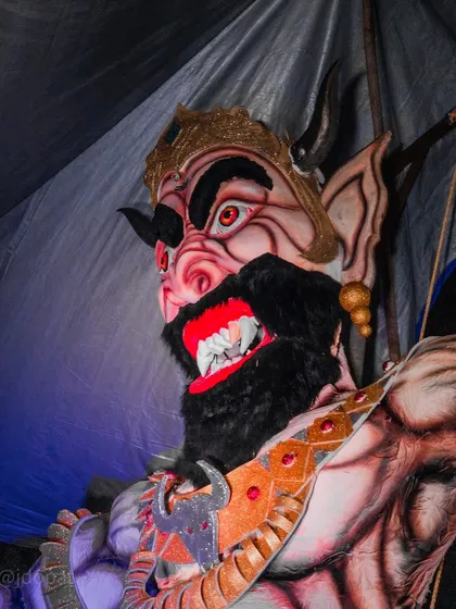 A close-up shot of the fearsome face of a Narakasura effigy, showcasing its detailed and menacing expression.