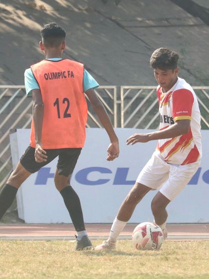 Another angle of a player skillfully protecting the ball from an opponent, showcasing strength and technique.