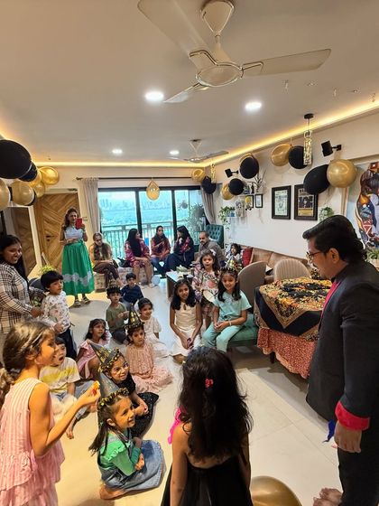 A living room full of excited kids and curious parents is the perfect audience. This is a typical scene from one of my house party magic shows, where I perform for the whole family.