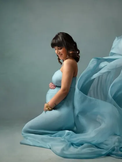 Whispers of blue. This soft, ethereal blue fabric creates a dreamy and calming mood, perfect for a serene and artistic maternity photo.