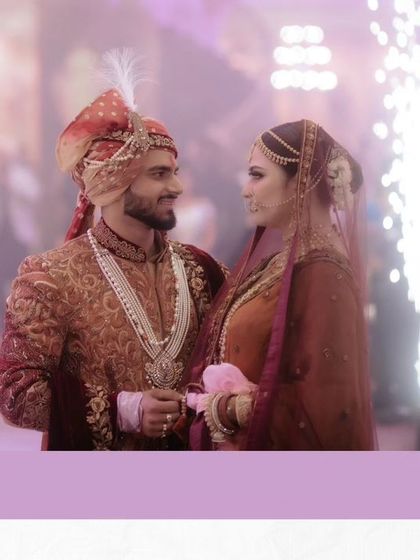 A romantic shot of Akhilesh and Nisha, their entry lit by sparklers, creating a magical and celebratory atmosphere.