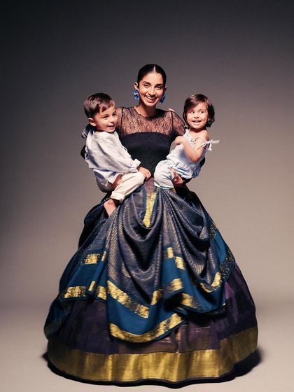 A mother and her children, styled in a voluminous Kanjivaram skirt. This image for Kanakavalli brings a sense of warmth and family to an otherwise high-fashion, conceptual shoot.