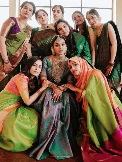 The bride, Arya, surrounded by her supportive and loving friends. This portrait captures the beautiful bond of friendship and the collective joy of the wedding day.