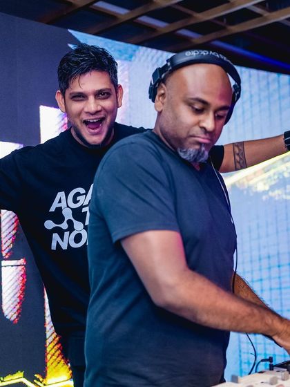 Having a great time with a fellow DJ behind the decks. The energy is always better when everyone is having fun.