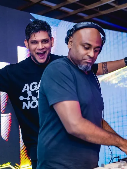 Having a great time with a fellow DJ behind the decks. The energy is always better when everyone is having fun.