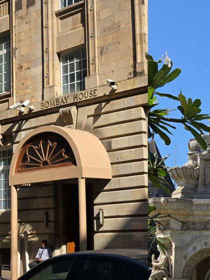 A split view of Bombay House and the Flora Fountain, capturing the contrast between corporate heritage and public art.