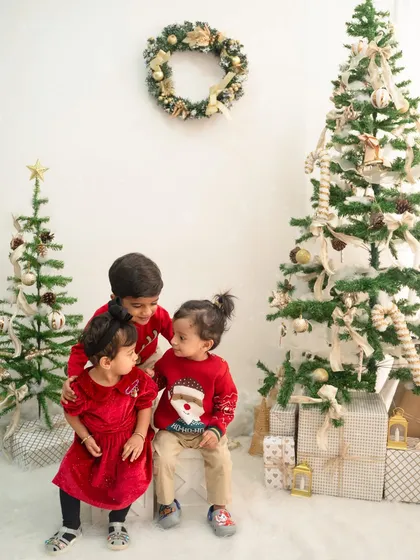 A festive Christmas portrait with three adorable siblings. Capturing the dynamic between siblings, from protective hugs to shared giggles, is one of my favorite things.
