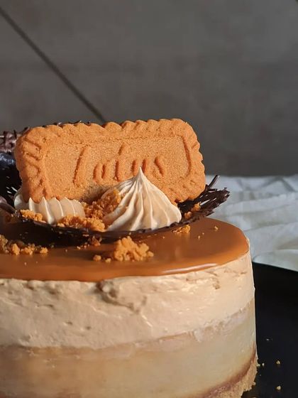 A close-up shot of the Lotus Biscoff cheesecake, highlighting the glossy Biscoff glaze and the signature biscuit on top.