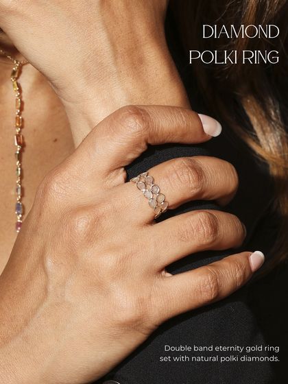 The Diamond Polki ring worn on the hand, demonstrating its pure finesse and how it can be stacked with other pieces like the Rainbow Sapphire chain.