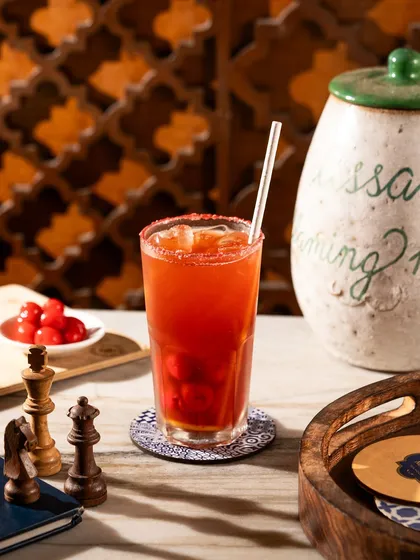A tall, refreshing cherry iced tea. This image is styled to feel like a relaxed afternoon, making it perfect for a cafe or tea house menu.