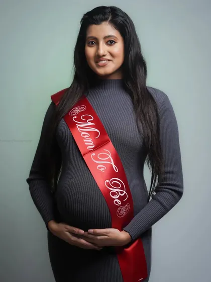 A simple and heartfelt studio maternity portrait. The focus here is on the "Mom To Be" and the quiet joy of this special time, using clean lighting to create a classic keepsake.