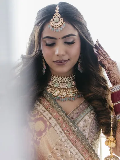 A delicate and ethereal shot. The soft waves and gentle makeup create a timeless and romantic bridal portrait.