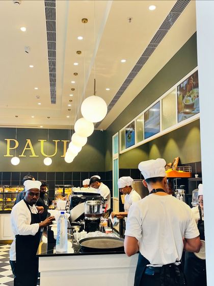 The busy kitchen and counter area inside PAUL, full of energy and inspiration for an urban sketcher.
