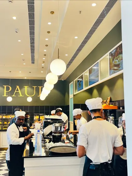 The busy kitchen and counter area inside PAUL, full of energy and inspiration for an urban sketcher.