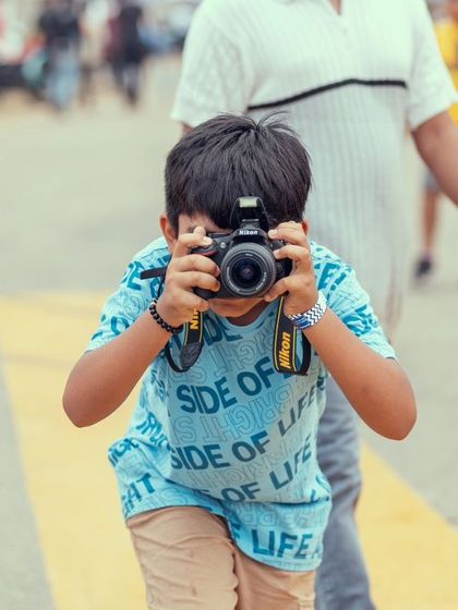 Another shot of a young photographer in the making. Our events bring together fans of all ages, united by a love for speed and spectacle.