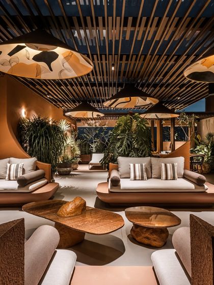 An intimate view of the lounge seating at night. The combination of ambient and accent lighting creates a cozy and sophisticated atmosphere, perfect for late-night conversations.