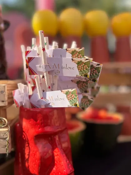 Personalized paper straws and tags, continuing the '#IAMINLOVE' wedding theme across all the bar details.