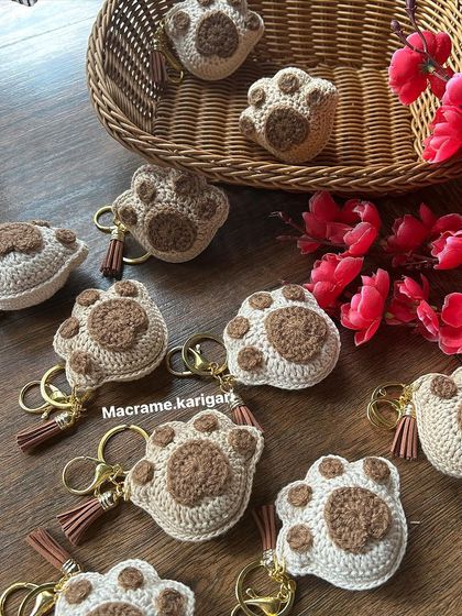 A collection of our crochet paw print keychains. They are a perfect gift for any dog lover, symbolizing the love we have for our pets.