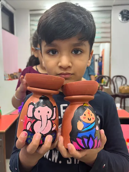 Another proud artist with his hand-painted Lakshmi and Ganesha tea-light holders.