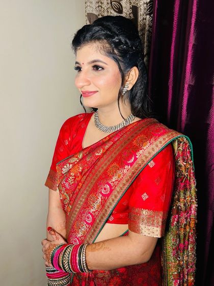 A soft and elegant look for a Roka ceremony, featuring a beautiful red saree and minimal jewellery.