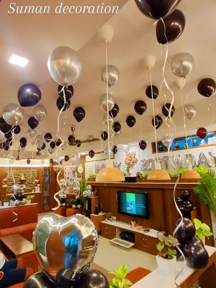 Another perspective of the black and silver room decor, demonstrating the full coverage of the ceiling balloons with hanging ribbons.