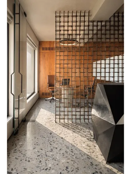We believe in finding beauty in everyday materials. In this South Delhi office for a construction firm, we reimagined common reinforced steel bars to create a delicate, permeable screen that elegantly separates the reception from the conference area.