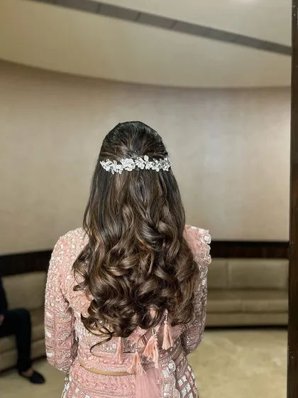 The back view of the reception hairstyle. The sparkling accessory adds the perfect amount of glam for an evening event.