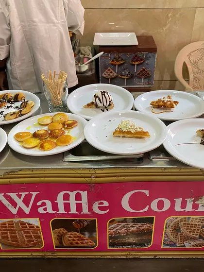 A variety of freshly made waffles and pancakes served with different toppings at our live dessert counter.