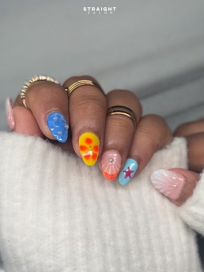 Another view of the vibrant, beachy nail art. Each nail tells a part of the story, from the textured water drops to the colorful starfish, making for a truly unique and eye-catching set.