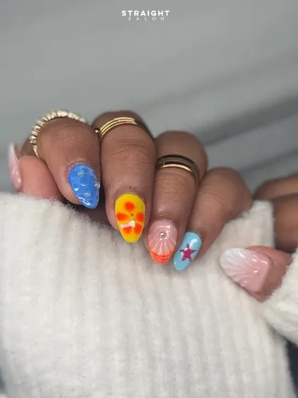 Another view of the vibrant, beachy nail art. Each nail tells a part of the story, from the textured water drops to the colorful starfish, making for a truly unique and eye-catching set.