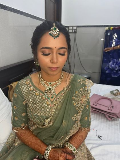 Another shot of Anitha's reception makeup, showing the flawless base and soft contouring that enhances her features naturally.