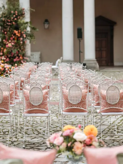 A perspective shot of the ceremony seating, leading the eye towards the beautiful floral mandap.