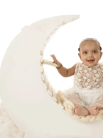 "Fly me to the moon." This dreamy sitter session setup with a moon prop and fluffy clouds is perfect for capturing your baby's magical spirit.