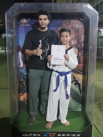 Every certificate marks a milestone in a student's journey. I am incredibly proud to guide them as they progress, belt by belt. This is me with one of my dedicated students, celebrating his hard-earned achievement.