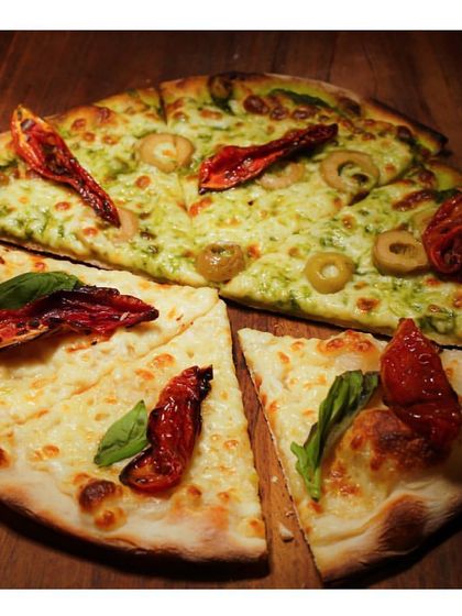 The aroma of freshly baked pizza is irresistible. We offer delicious pizzas with a variety of toppings, from classic cheese and basil to pesto with olives.