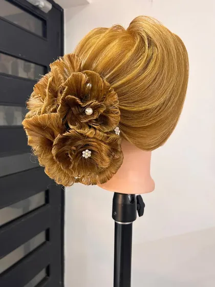 A close-up of the floral bun, highlighting the clean finish and secure construction.