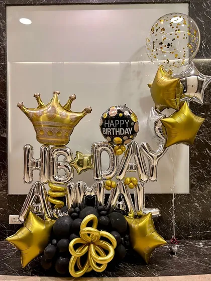 This is for when you want to make a big, bold statement with balloons. I created this custom 'Happy Birthday Amma' balloon bouquet with a crown, stars, and a black and gold theme for a truly royal celebration.