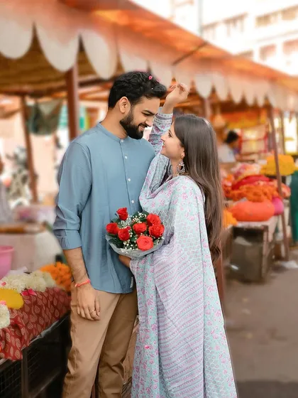 A playful moment in the flower market, as the bride showers the groom with petals.
