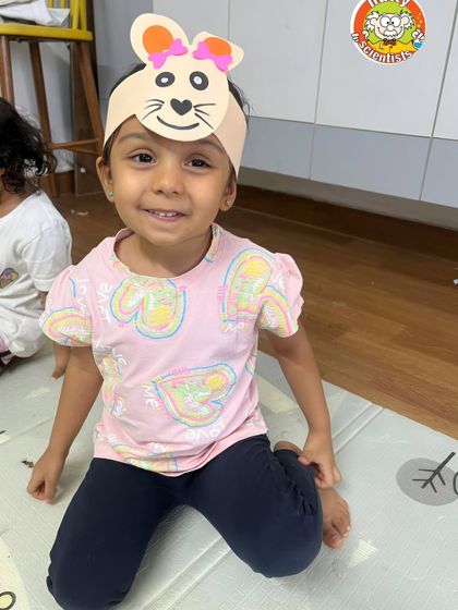 This little camper is all smiles with her handmade bunny ears, blending science with silly, creative fun.