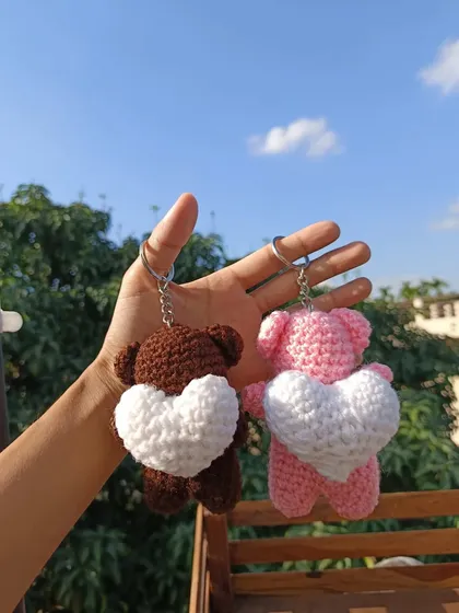 A pair of my heart-holding bear keychains in brown and pink. These are a lovely item for gift shops.