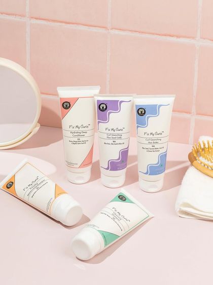 We created a realistic bathroom counter scene for this curly hair care line. The pink tiles, mirror, and brush help customers visualize the products as part of their daily routine.