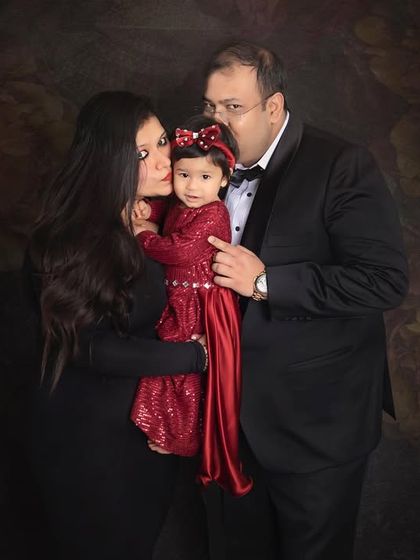 Sweet kisses for their little girl. This photo is overflowing with love and affection, a perfect capture of this family's bond.