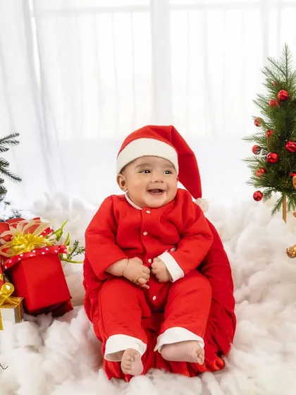A big, happy smile from the jolliest little Santa. This shot captures the pure joy of the holiday season.
