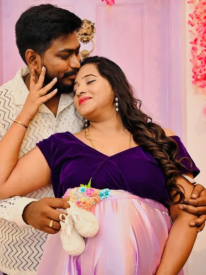 A close up, tender moment between an expecting couple. The tiny baby shoes are a sweet prop that adds a layer of emotion and anticipation to the photograph.